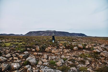 Young girl takes pictures of icelandic landscapes. Iceland, summerの写真素材