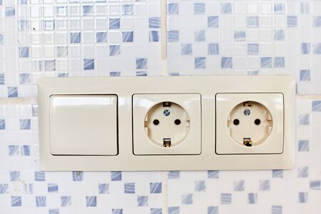Two white 220-volt outlets with a switch.