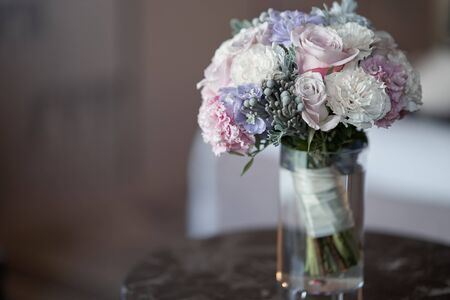 Bridal bouquet stands in a vase on the table.の写真素材