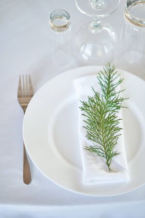 Wedding decorations. White plates on a white tablecloth. Natural style wedding.の写真素材