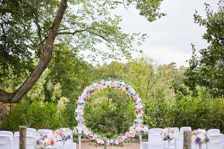Wedding arch on the street from artificial flowers. Decor wedding celebration. Wedding celebrationの写真素材