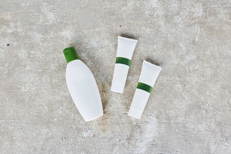 Blank cosmetic containers on grey background. Skincare cosmetic products. Mockupの写真素材