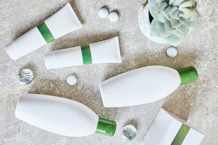 Blank cosmetic containers on grey background. Skincare cosmetic products. Mockupの写真素材