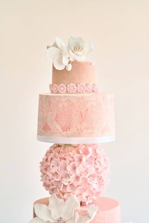 Big layered cake show. Pink cake with white roses.の写真素材