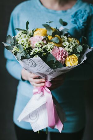 Beautiful bouquet of flowers in the hands of a woman.の写真素材