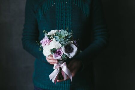 Beautiful bouquet of flowers in the hands of a woman.