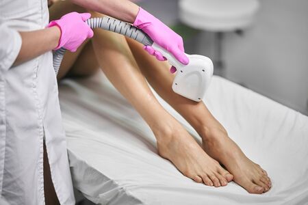 Young girl on a laser hair removal procedure. Laser Hair Removal Cabinetの写真素材