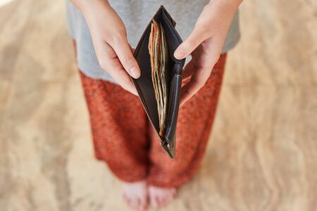 Indian rupees in a wallet. The wallet in the hands of a girl with Indian rupees.の写真素材