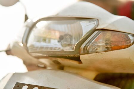 A girl in a green dress drives a scooter. A young girl rides a scooter.の写真素材
