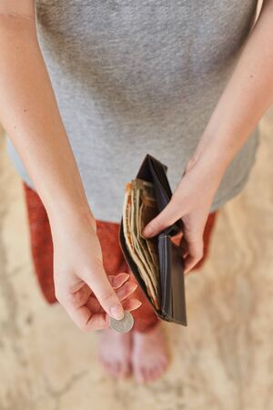 A young girl pays Indian rupees. The girl pays. A Girl gives moneyの写真素材