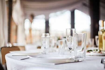 Table set for an event party or wedding reception. Banquet table design. Festive table setting....
