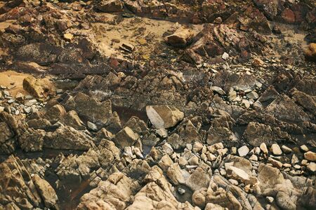 The rocky texture on the ocean. Goa coast, Arambol.