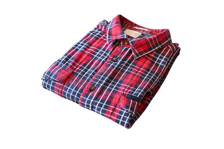 red checkered flannel shirt folded on a white isolated background