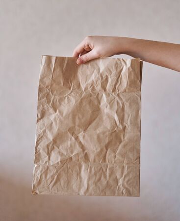 Girl holds an eco-friendly paper bag. Close-upの写真素材