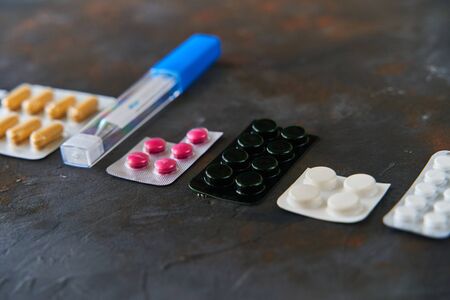 Pills capsules medicine health on dark background, top viewの写真素材