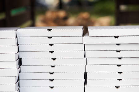Stack of white cardboard pizza packages. Pizza packages close-upの写真素材