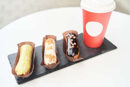 Three eclairs on a black tray top viewの写真素材