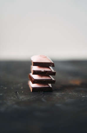 Selective Focus on Four Chocolate Slices on a Dark Background.