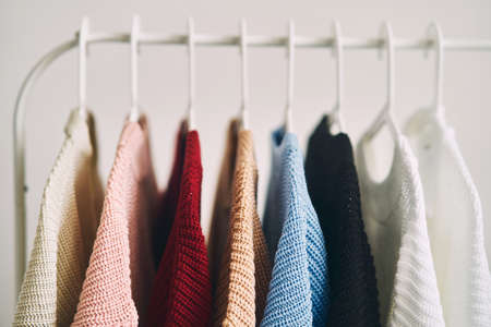 multicolored womens woolen sweaters on hangers. Sale in a fashion store