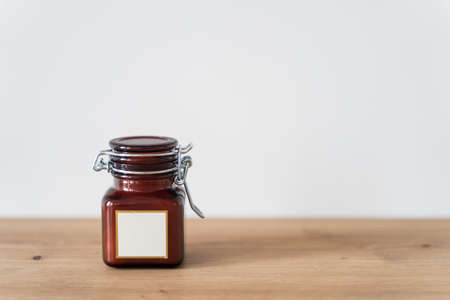Scented candle in a glass jar on a white backgroundの写真素材