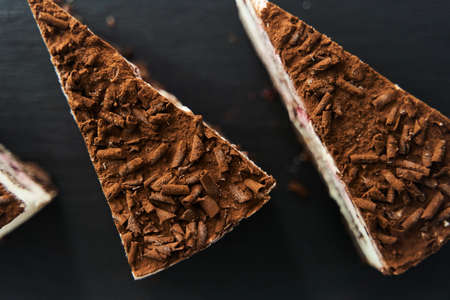 a slice of chocolate chip cake on a black trayの写真素材