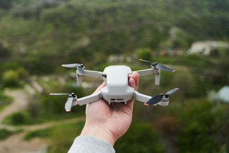 Modern small compact quadcopter in a mans hand. Launching a drone from your handの写真素材