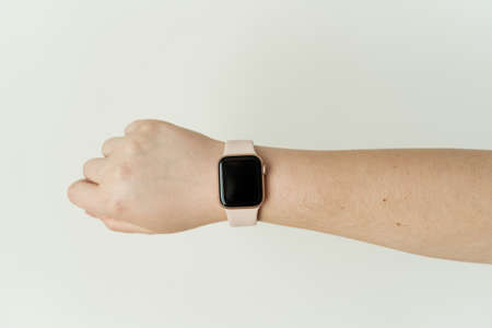 Kaliningrad, Russia - March 9, 2021: Apple watch on hand at a young woman.のeditorial素材