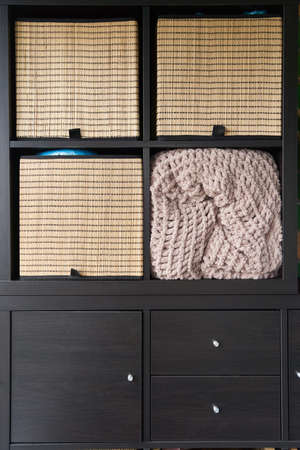 Wicker boxes for things on the shelves. Wardrobe for storage of thingsの写真素材