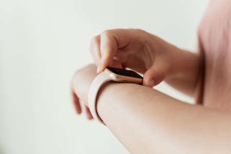 Kaliningrad, Russia - March 9, 2021: Apple watch on hand at a young woman.のeditorial素材