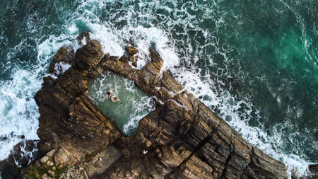 Aerial view of a girl who swims in a natural pool. View of Gurubebila natural sand poolの写真素材