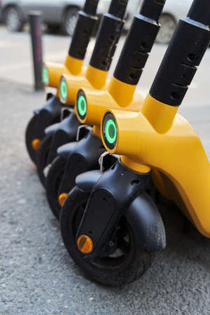 Electric scooters for rental . Vehicle rent service background. Electric kick scooters for...