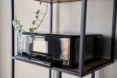 Black inkjet printer is on the shelfの写真素材