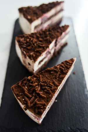 a slice of chocolate chip cake on a black tray