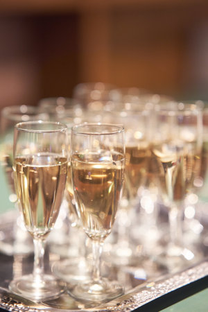 Glasses of champagne on a silver tray at a family celebrationの写真素材