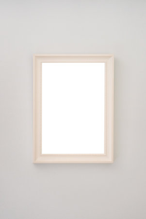Beige empty photo frame hanging on the wall
