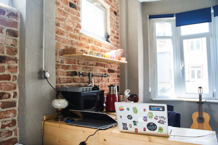 Istanbul, Turkey - May 2, 2021: A small kitchen with brick walls. Laptops on the table. Working from...
