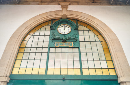 Porto, Portugal - 25.12.2022: Vintage station clock in Sao Bento Train Station, famous for its azulejo tiled walls.のeditorial素材