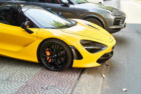 Ho Chi Minh City, Vietnam - 05.07.2023: a yellow sports car is parked next to a black sports carのeditorial素材