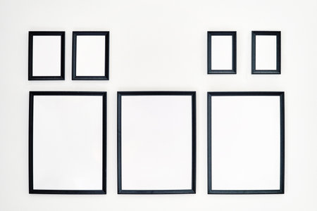 Different size framed photos hanging on the wallの写真素材