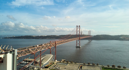 Aerial view of 25th April Bridge in Lisbon, Portugal. Famous landmark on river Tagus.
