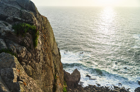 Witness the Stunning Coastal View at Sunset Featuring Beautiful Rocky Cliffs and the Sea