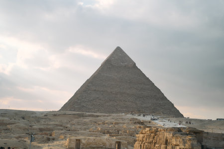 The Majestic Pyramids of Giza Stand Tall Against a Dramatic, Cloudy Sky Above Themの写真素材