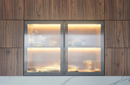 Explore the elegance of Modern Wooden Kitchen Cabinets, featuring beautiful glass display elementsの写真素材
