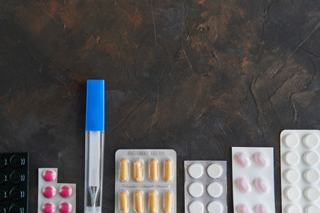 Pills capsules medicine health on dark background, top viewの写真素材
