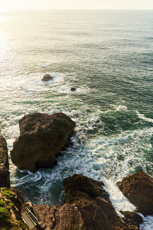 Experience the Serene and Beautiful Coastal Waves at Sunset, a breathtaking natural moment