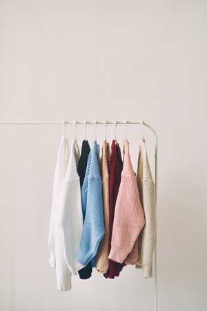 multicolored womens woolen sweaters on hangers. Sale in a fashion storeの写真素材