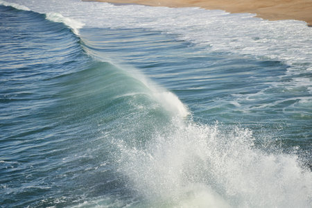 a close up of a body of water with waves crashing on the shore