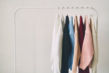 multicolored womens woolen sweaters on hangers. Sale in a fashion storeの写真素材