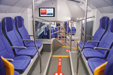 Modern high speed train interior with empty blue seats