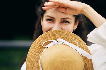 Young beautiful girl in a hat in a summer park